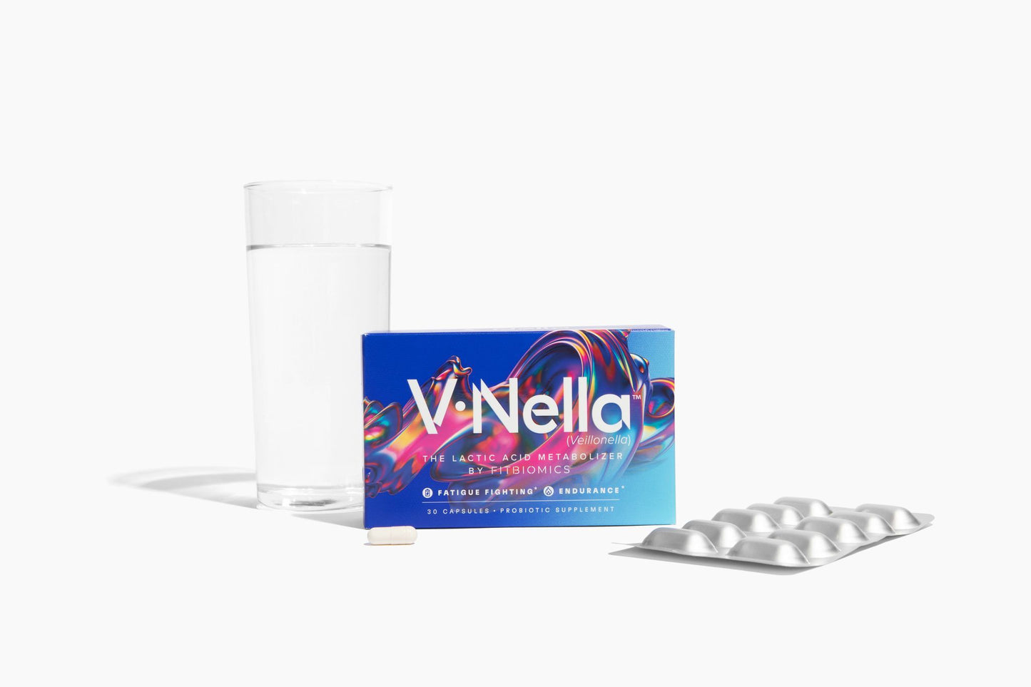 a box of v•nella with a glass of water behind it and a capsule and blister card in front